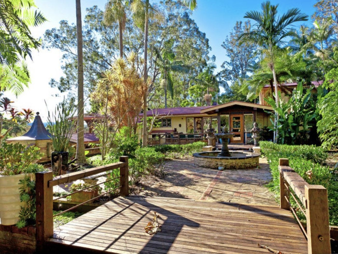 Timber decking, water feature and tropical garden on the property